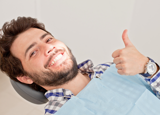 dental patient giving thumbs up