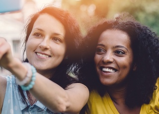 Two teen girls smiling together